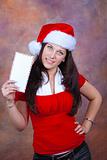 young girl smiling with red christmas clothes and envelope