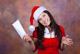 young girl smiling with red christmas clothes and envelope