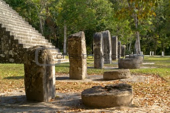 Row of altar stones in front of a contemporary Maya tempel,Tikal