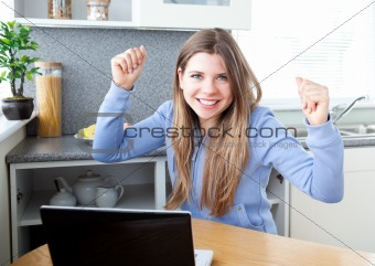 Cheering girl in front of her laptop