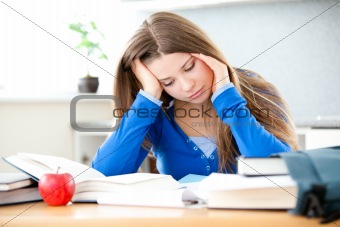 Young girl studing in living room
