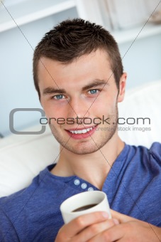Smiling man drinking a coffee