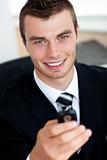 Young businessman holding mobile phone