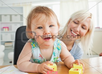 Glad mother playing with her daughter