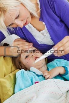 Sick female child lying on couch