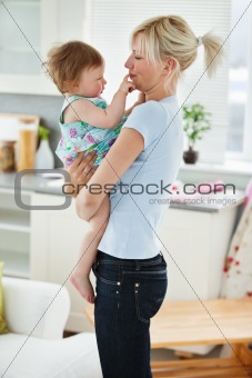 Young mother playing with her daughter