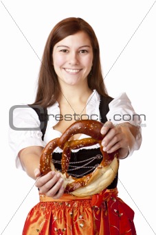 Young Bavarian woman holding Bavarian Oktoberfest Pretzel