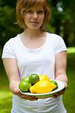 Girl holding a bowl of lemon and lime