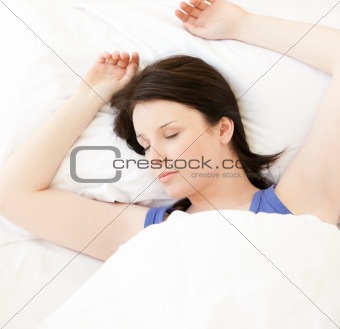 Cute young woman sleeping in her bed 
