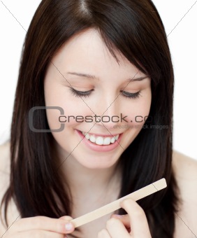 Portrait of a beautiful woman filing her nails 