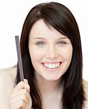 Portrait of an animated young woman holding a nail file 