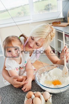 Mother and smiling child baking cookies 