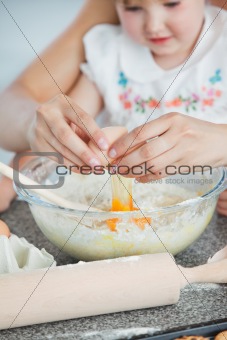 Mother and small child baking cookies 