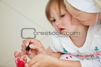 Happy mother playing with her amazed daughter
