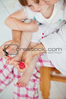 Mother making her daughter's nails