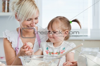 Smiling Mother and child baking cookies