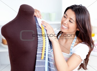 Glowing young woman working with clothes