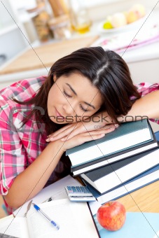 Tired asian student sleeping on her books 