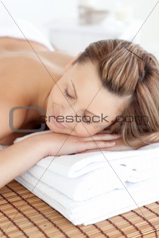 Relaxed caucasian woman lying on a massage table with closed eye