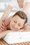 Smiling caucasian woman receiving a back massage