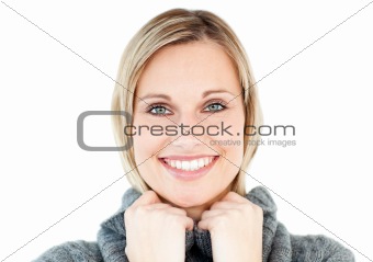Smiling woman wearing a polo-neck sweater looking at the camera 