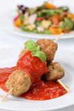 Meatballs on skewers with tomato sauce