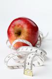 Tape measure and red apple