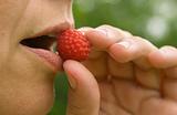 woman eats berries raspberries