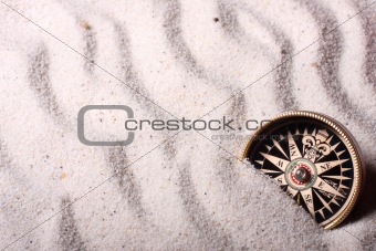 Compass in sand
