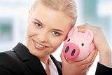 Businesswoman and piggy bank