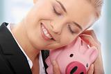 Businesswoman holding piggy bank