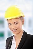 Confident female worker in helmet