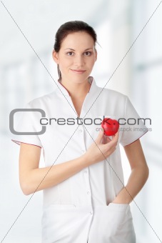 Young nurse with heart in her hand