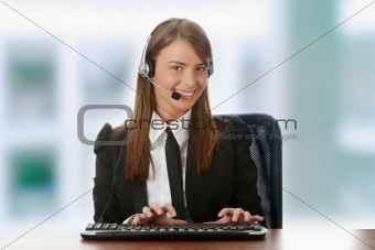 Young beautiful customer service operator girl in headset