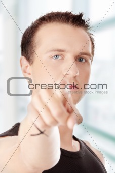 Young caucasian man, pointing at camera.