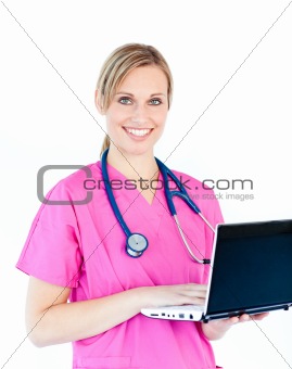 Delighted female nurse holding a laptop smiling at the camera 
