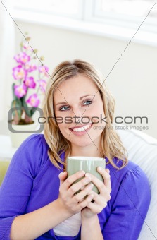 Charming woman holding cup