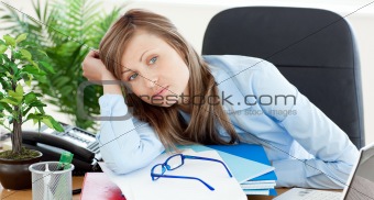 Bored businesswoman sitting at her desk 