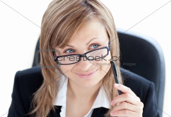Charismatic businesswoman holding a pen wearing glasses