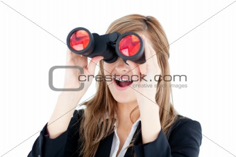 Fascinated young businesswoman looking through a spyglass
