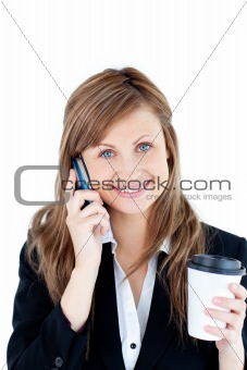 Smiling businesswoman talking on phone holding a coffee