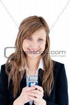 Radiant businesswoman writing a message with her cellphone 