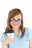 Pretty caucasian businesswoman holding a coffee wearing glasses