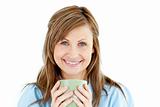 Cute woman holding a cup of coffee smiling at the camera 