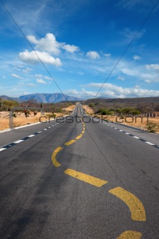 Twisting lane marking on road in desert