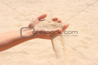 Sand running through hands