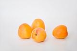 Four fresh apricots on white background