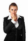 modern business woman with finger at mouth. shh gesture