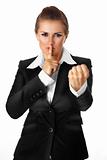 modern business woman with finger at mouth and threatenwith fist