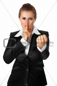 modern business woman with finger at mouth and threaten
with fist